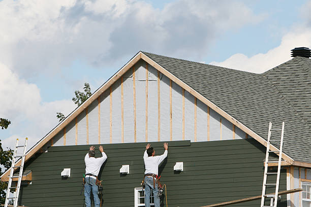Professional Storm Damage Siding Repair technician working in Lowell, MA